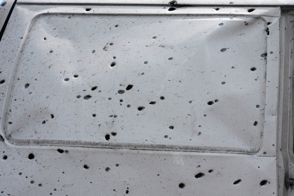 A shrapnel-damaged car door is seen among the ruins of city market place following Russian missile attack in Kyiv (AP)