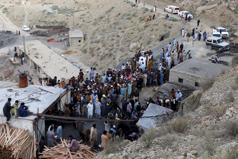 People gather after an explosion buried parts of a coal mining complex (Reuters)