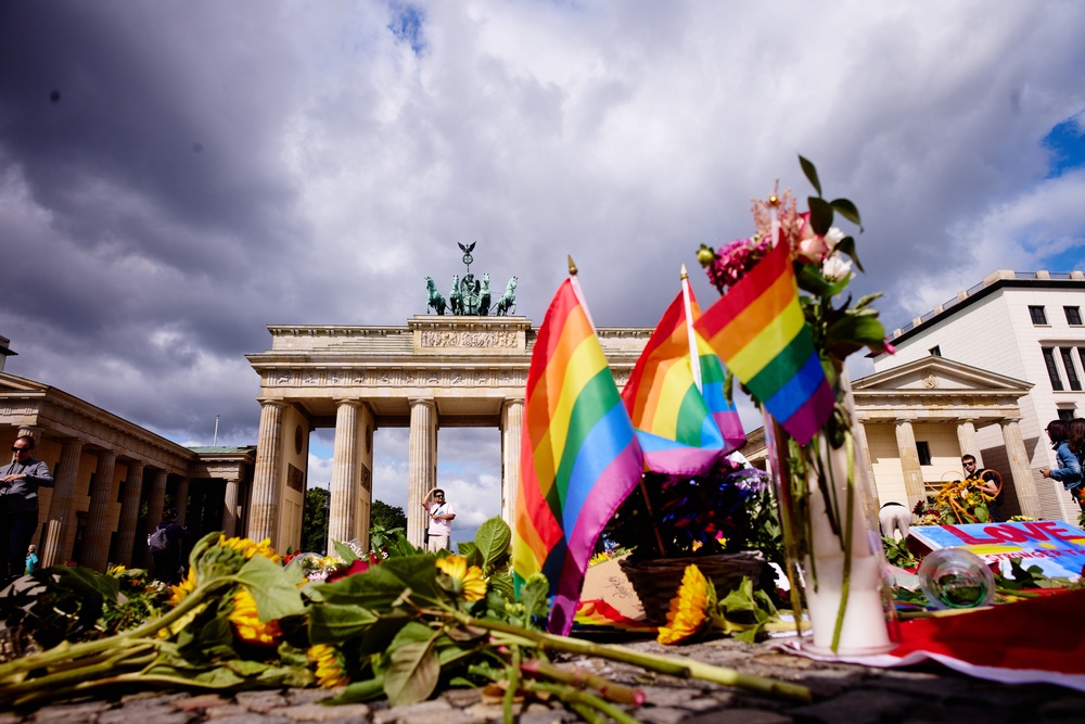 Flowers and rainbow flags placed in front of the Brandenburg Gate commemorating the victims of an attack on Saturday’s Pride March (Markus Schreiber/AP) (AP)