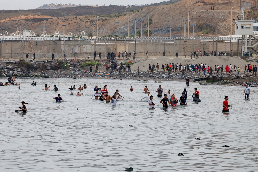 Migrants crossed through water to enter the Spanish territory (Reuters)