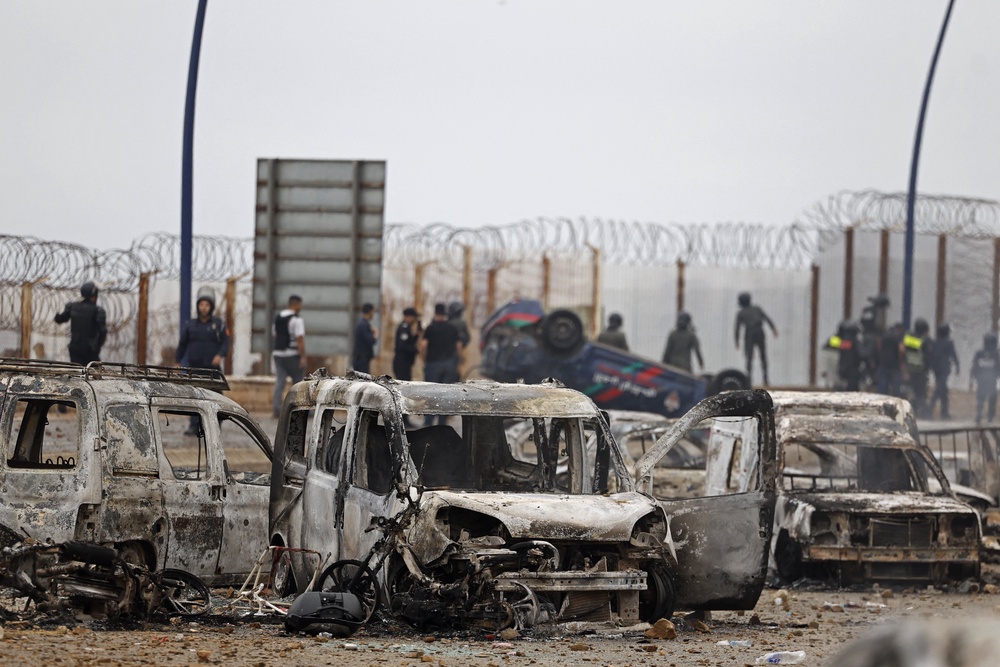 Damaged and burnt vehicles are pictured at the site of clashes near Fnideq, on the Morocco-Spain border, on July 31, 2026 (Photo by Abdel Majid BZIOUAT / AFP via Getty Images) (AFP/Getty)