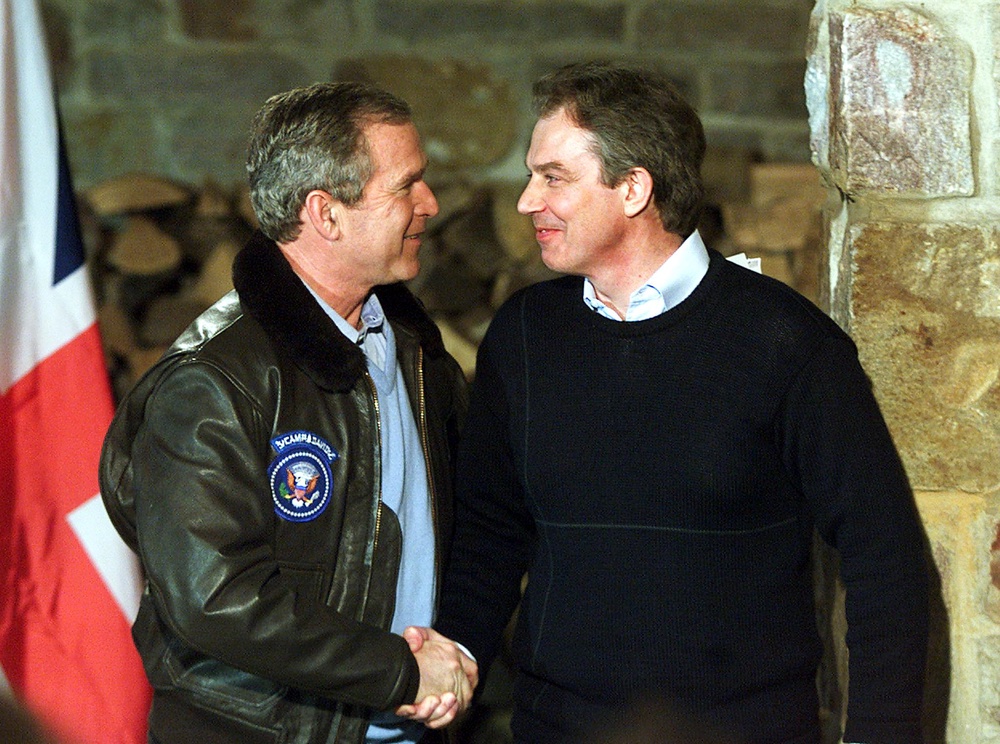 Former President George W. Bush (L) and former  British Prime Minister Tony Blair shake hands after a joint press conference 23 February 2001, in Thurmont, Maryland, down the road from the presidential retreat Camp David (AFP/Getty)
