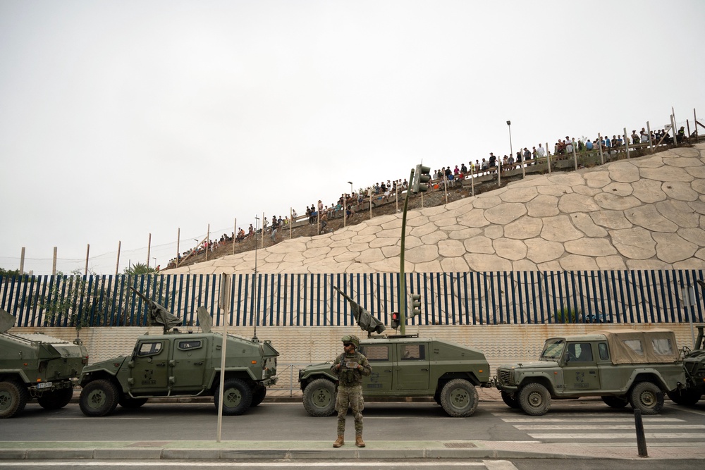 The military has been drawn out to help police the border after thousands of people crossed by land and sea on Thursday (AFP/Getty)