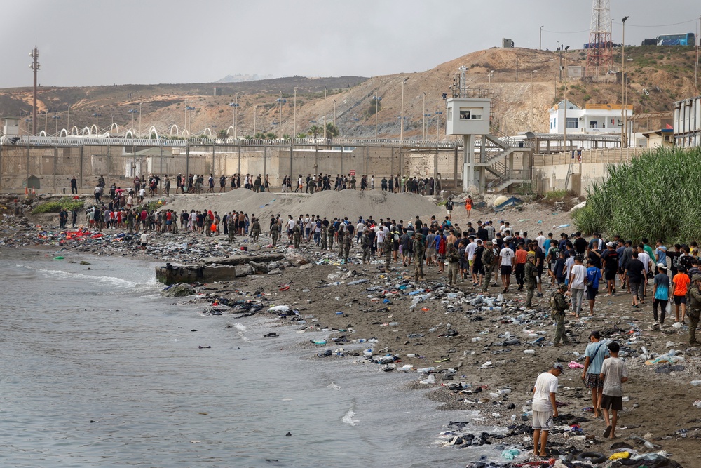 People walk towards the border with Morocco leaving Spain, amid mass crossings of migrants on foot and by sea from Morocco into Spanish territory, in Ceuta, Spain, July 31, 2026. (REUTERS/Jon Nazca) (Reuters)