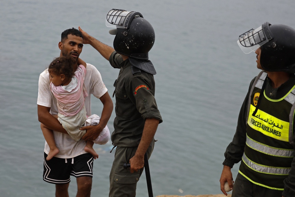 Children were among the crowds trying to make it across the border (AFP/Getty)