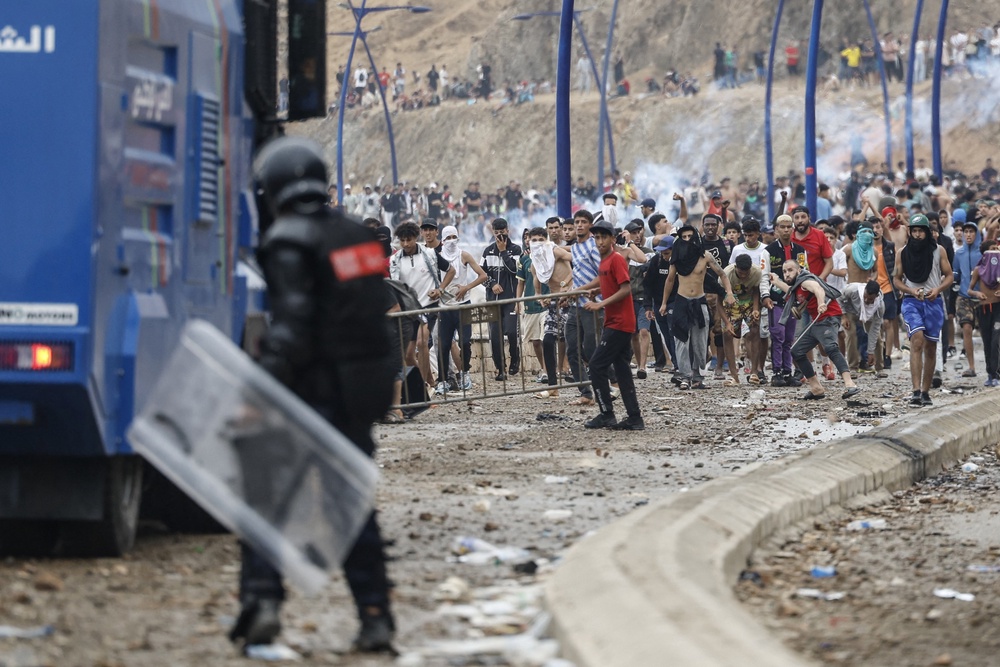Moroccan security forces clash with migrants attempting to cross into Spain's North African enclave of Ceuta near the town of Fnideq (Photo by Abdel Majid BZIOUAT / AFP via Getty Images) (AFP/Getty)