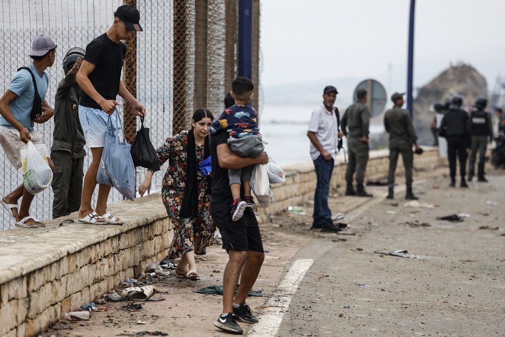A woman reacts during clashes between Moroccan security forces and migrants (Photo by Abdel Majid BZIOUAT / AFP via Getty Images) (AFP/Getty)