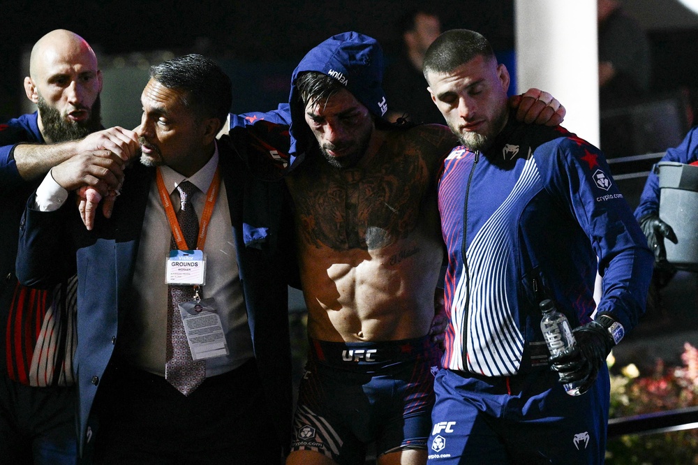 Ilia Topuria (centre) after his defeat by Gaethje (AFP/Getty)