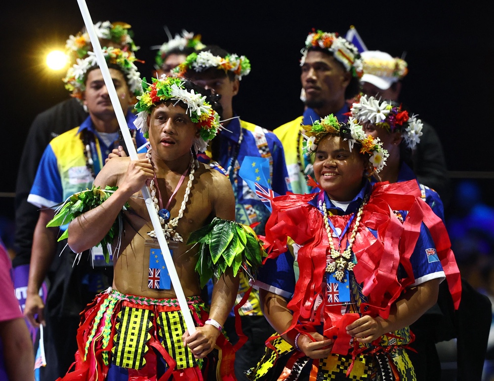 Siblings Tarona and Pasoni Taafaki lead athletes of Tuvalu during the opening ceremony (Reuters)
