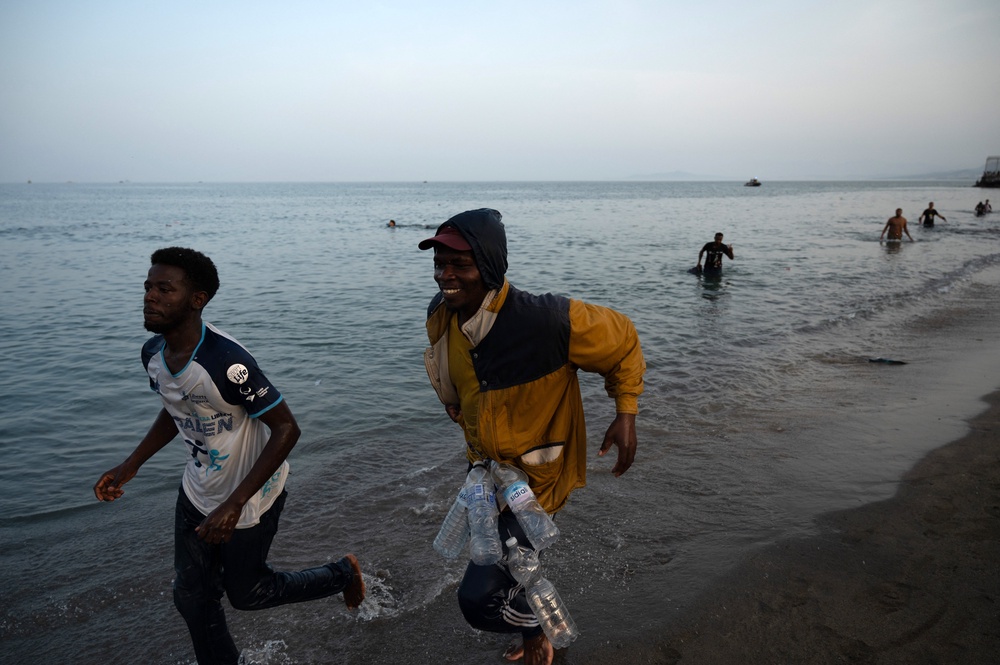 Migrants arrive on the shore after swimming into the Spanish enclave of Ceuta in North Africa (AFP/Getty)