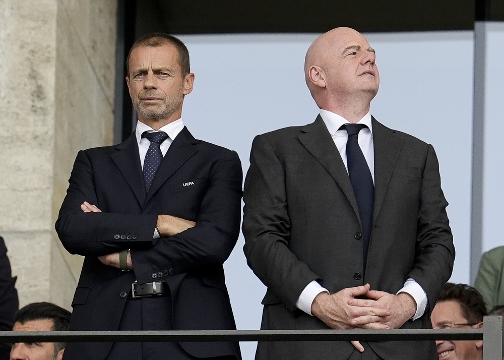 Ceferin (left) could be a challenger to Infantino (right) (PA)