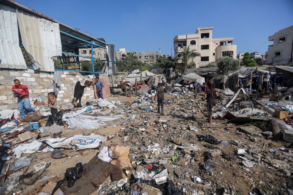 Residents inspect the damage caused by Israeli airstrikes on Friday evening (Getty)