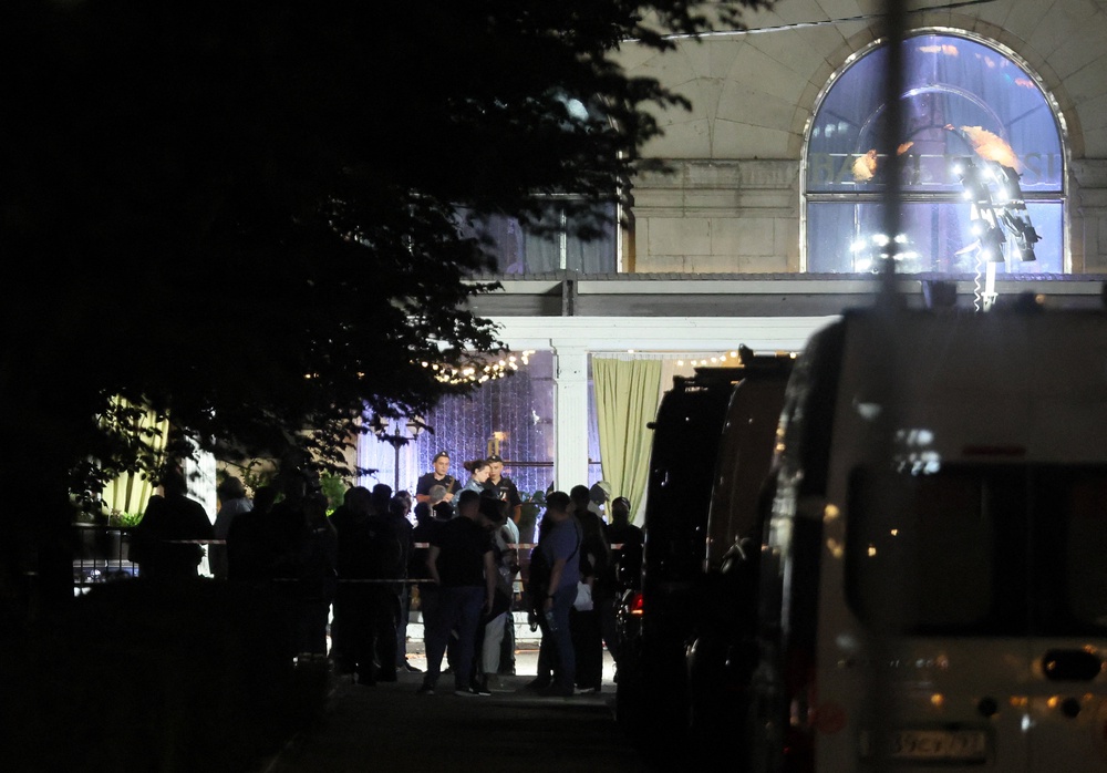 Law enforcement officers and emergency services personnel work at the site of an explosion at a restaurant in central Moscow (Reuters)