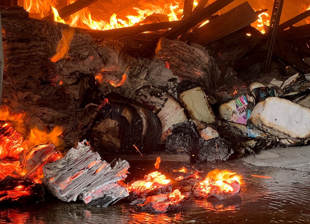 Books burn at the site of a book warehouse hit by a Russian drone strike, amid Russia's attack on Ukraine, in Kharkiv, Ukraine (Reuters)