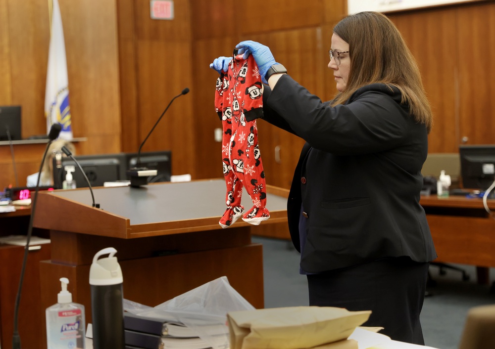 Assistant District Attorney Jennifer Sprague holds up as evidence the pajamas of Callan Clancy during the trial at Plymouth Superior Court (The Boston Globe)
