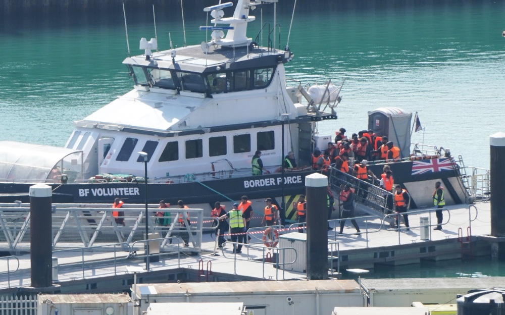 A group of people thought to be migrants are brought in to the Border Security Command compound in Dover, Kent (Gareth Fuller/PA) (PA Wire)