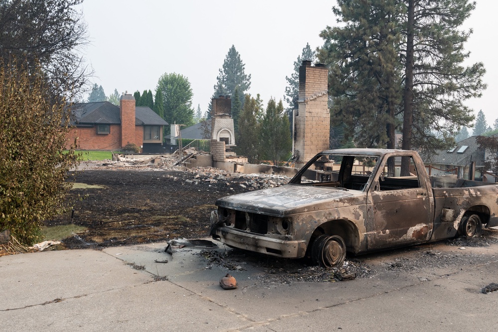 A burned out pickup truck sits in the driveway of what was once a residential home in Balboa (AFP/Getty)
