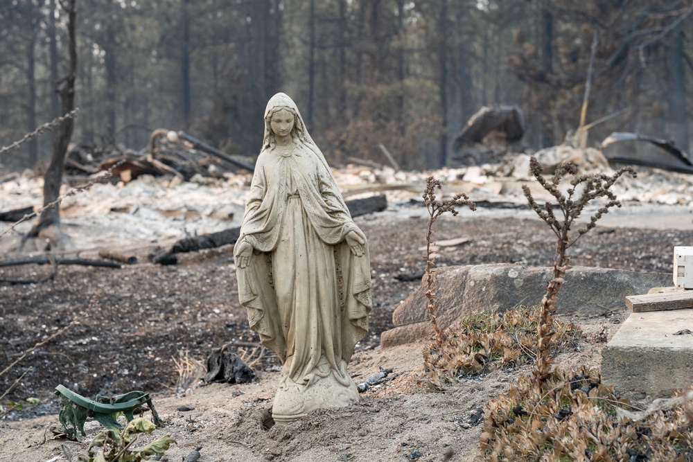 An untouched statue of the Virgin Mary is all that remains of a property in Spokane’s Balboa neighborhood after this weekend’s fast-moving wildfires (AFP/Getty)