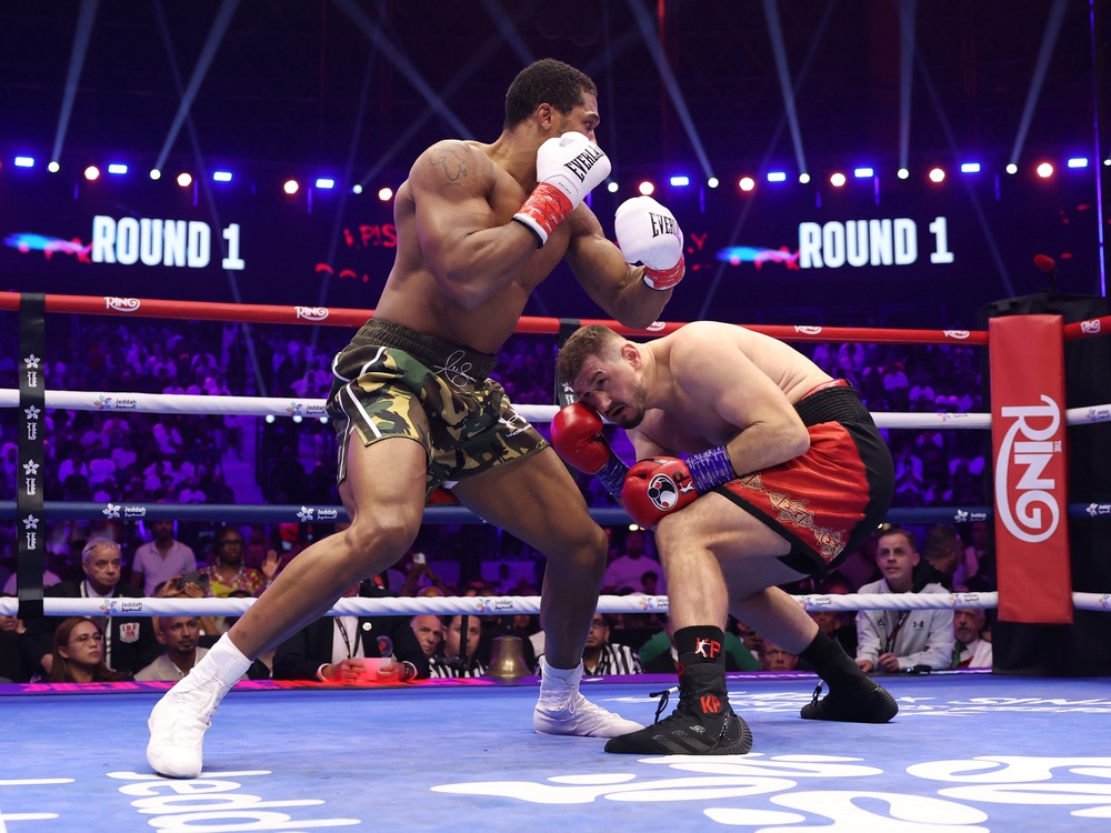 Anthony Joshua (left) stopped Kristian Prenga in round two (Getty)