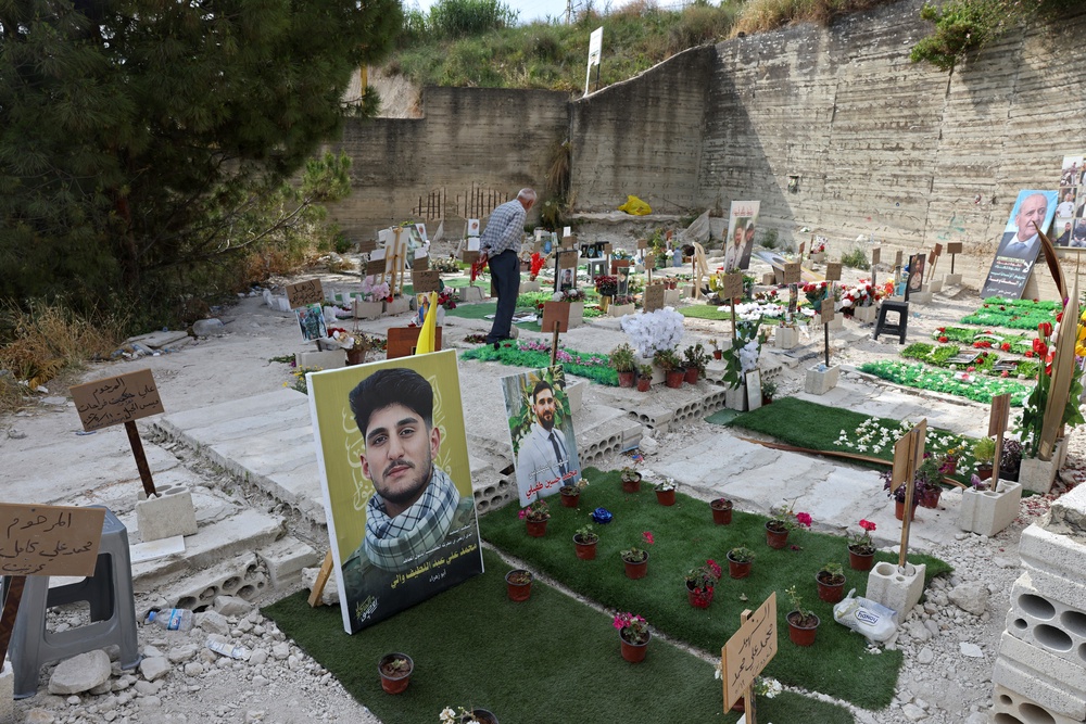 A man walks inside a temporary cemetery built for Hezbollah fighters and civilians killed during the ongoing war, in the southern coastal Lebanese city of Sidon on June 11 (AFP/Getty)