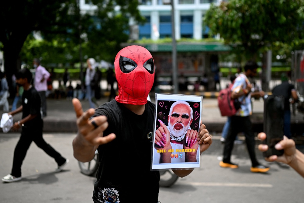 A protester holds a placard of India's prime minister Narendra Modi in Delhi (AFP/Getty)