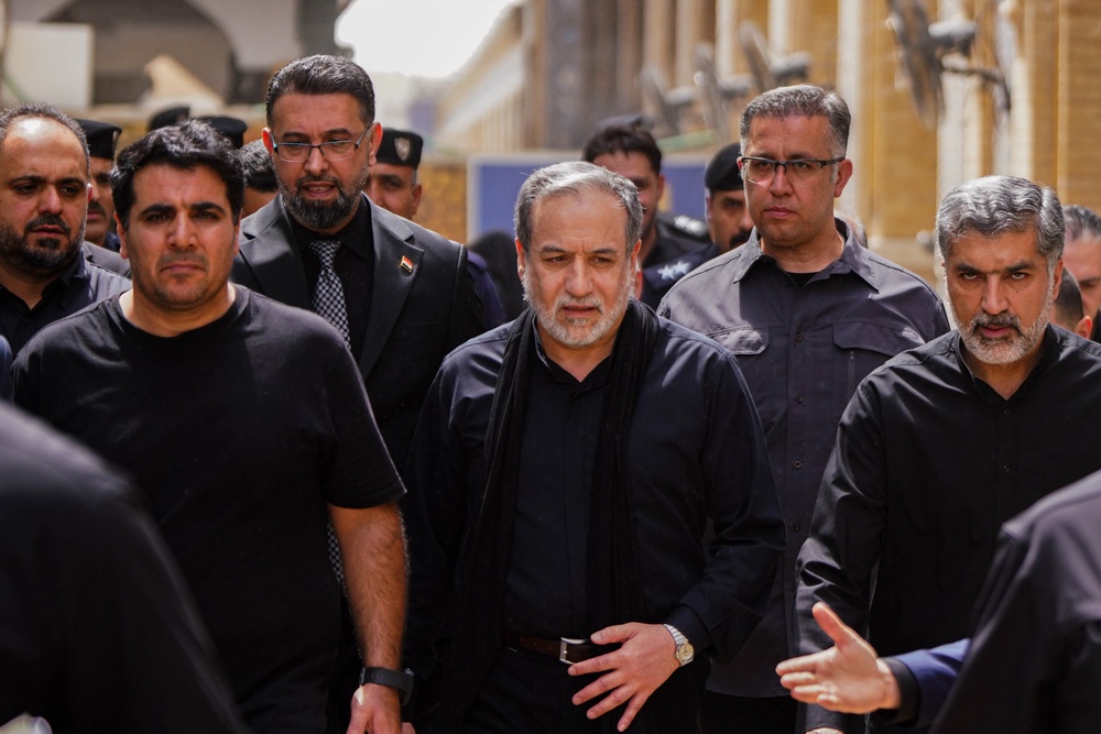 Abbas Araghchi, center, is surrounded by security personnel as he walks during the Arbaeen commemoration in Najaf, Iraq, (AP)