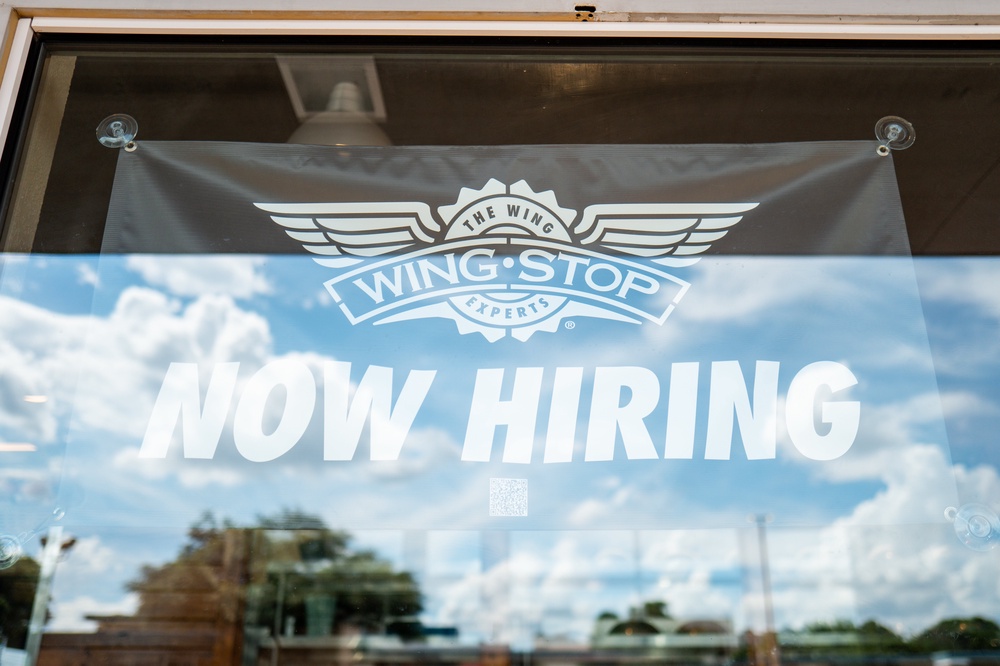 A hiring sign is displayed in a Wingstop store window on June 25, 2025 in Austin, Texas. (Getty)