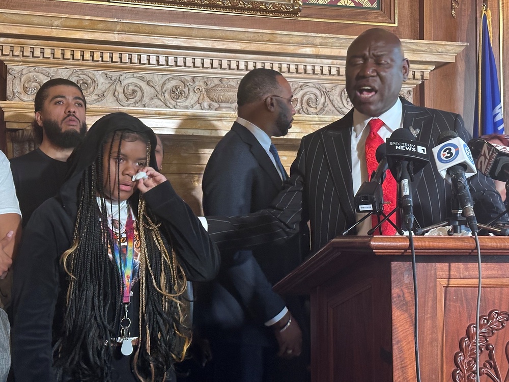 Kah'liyah Aliomar, the daughter of Corey Ruiz, wipes away tears as attorney Ben Crump speaks at a news conference on July 24 in Madison, Wisconsin (AP)