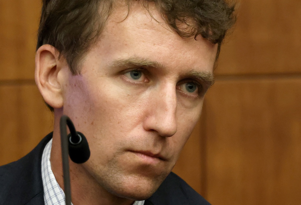 Patrick Clancy, the father of Cora, Dawson and Callan Clancy, looks on from the stand (Reuters)