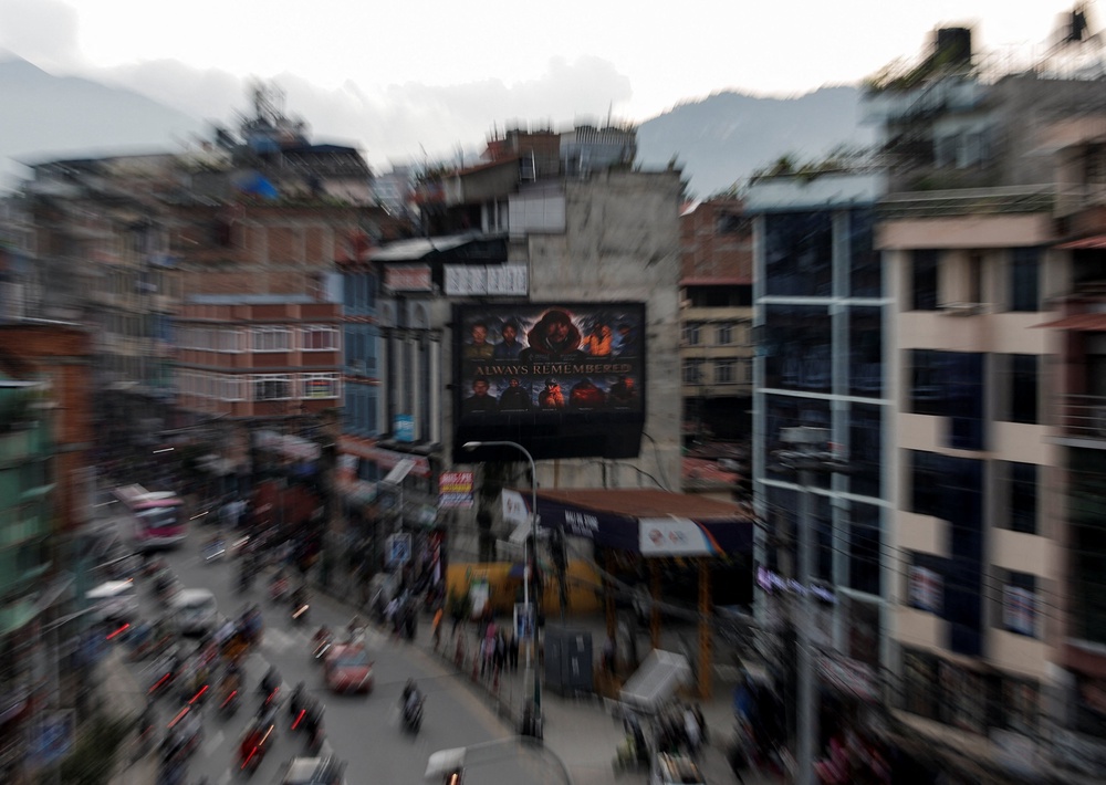 A digital board in Kathmandu displays a condolence message along with pictures of the climbers who lost their lives on Broad Peak (Reuters)