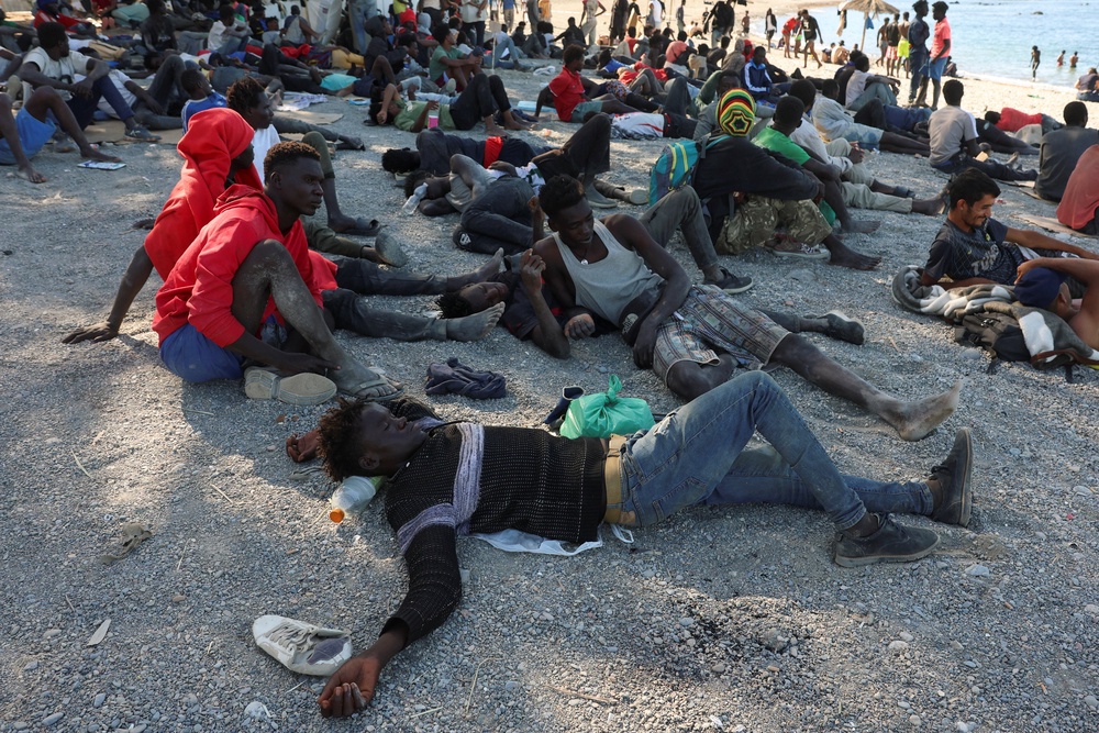 Migrants wait at a beach in Ceuta, Spain, following deadly mass crossings of migrants on foot and by sea from Morocco into Spanish territory, August 3, 2026. REUTERS/Violeta Santos Moura (Reuters)