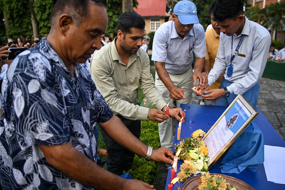 Mourners light candles for Nirmal Purja and his fellow climbers at Small Heaven School in Chitwan on 2 August 2026 (AFP/Getty)