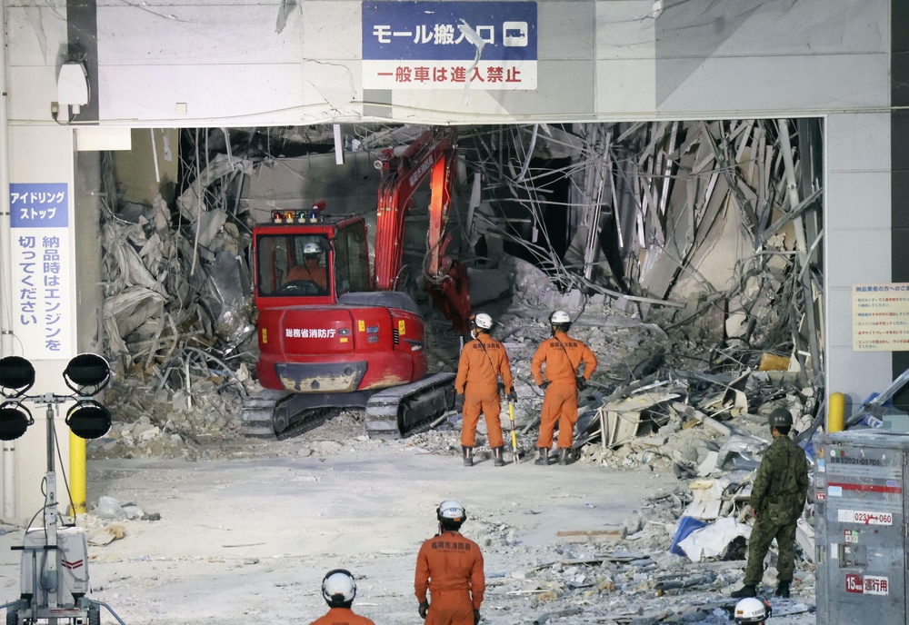 Heavy machinery removes debris at AEON Mall, which was damaged by an explosion following an earthquake, in Kashima, Kumamoto Prefecture (AP)