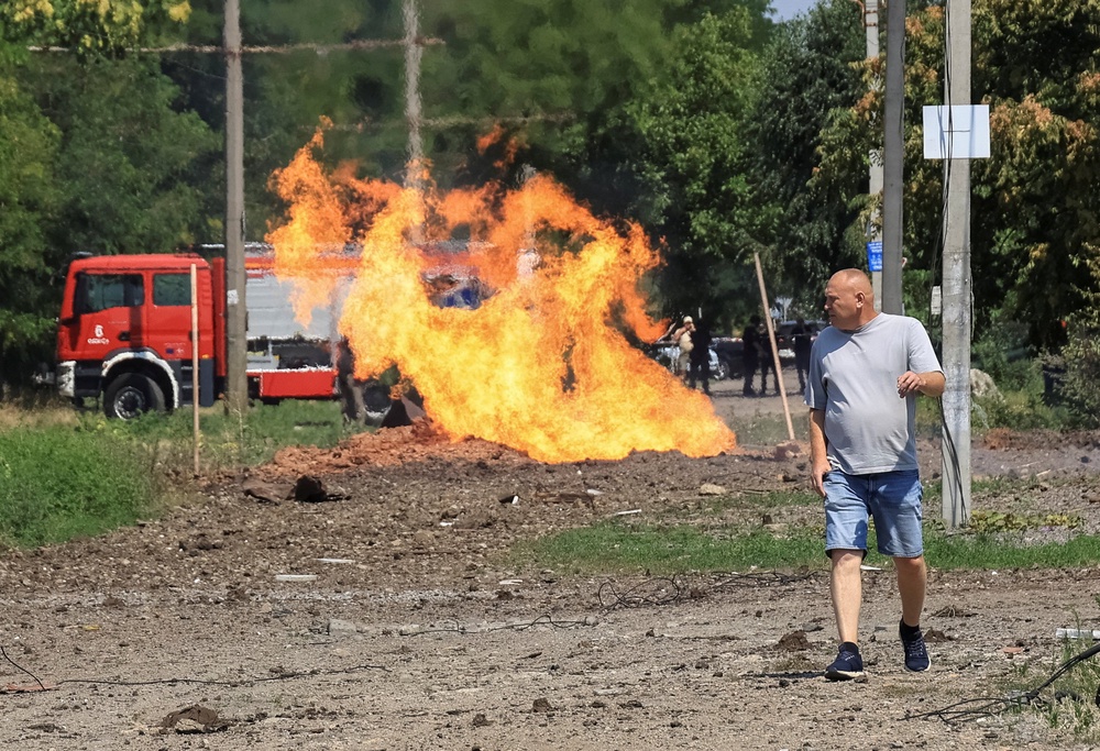 A resident walks at a site of a Russian missile strike in Odesa (Reuters)
