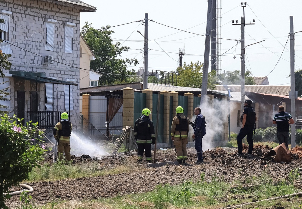 Rescuers work at a site of a Russian missile strike (Reuters)