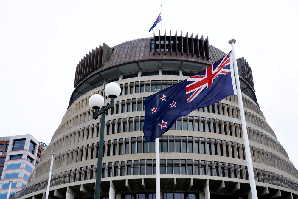 New Zealand's flag flutters in front of 'The Beehive', the executive wing of the New Zealand Parliament Buildings (Reuters)
