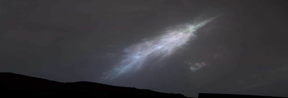 A feather-shaped iridescent cloud was captured by NASA’s Curiosity Mars rover just after sunset in January 2023. NASA says the clouds form from dry ice on the Red Planet (NASA/JPL-Caltech/MSSS)