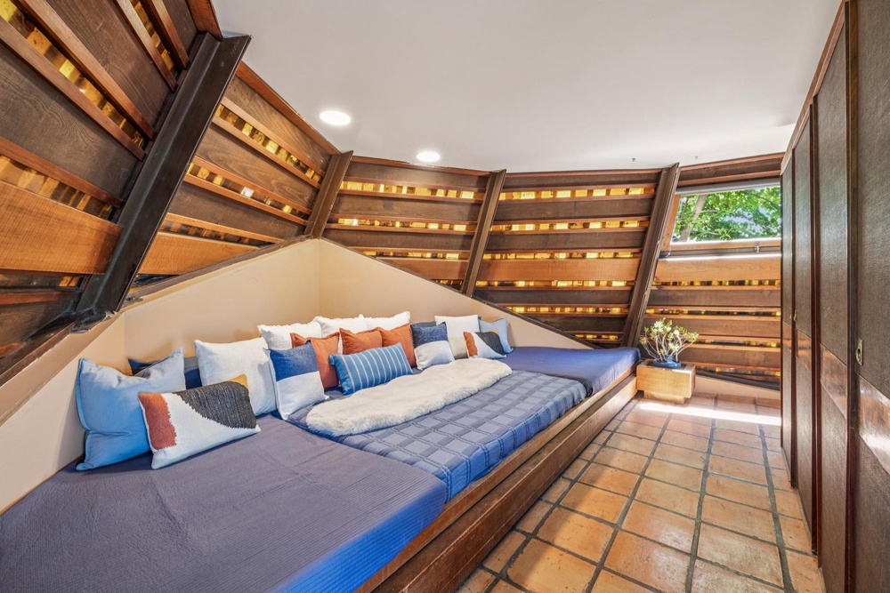 A nook with a built-in bed on the ground level serves as the primary bedroom (Open Homes Photography)