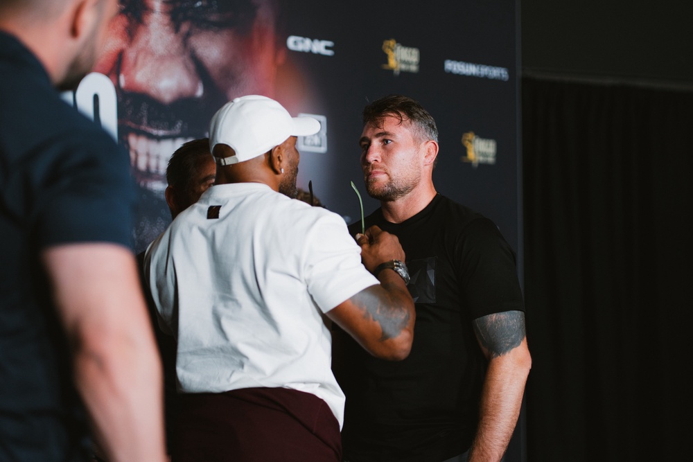 Yoel Romero (left) takes off his glasses as the stare-down intensifies (BKFC)