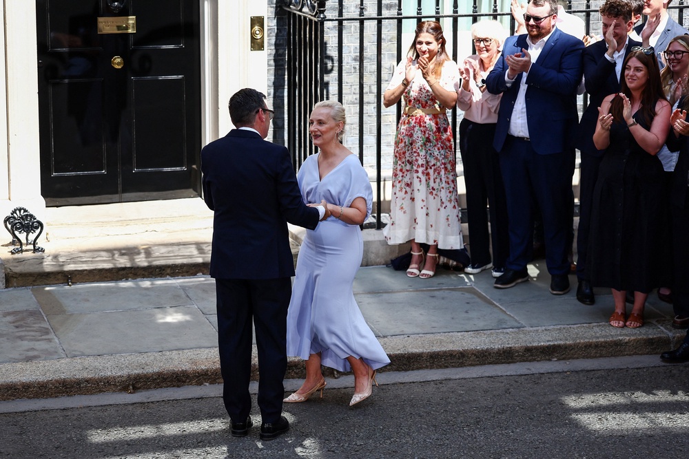Andy Burnham kisses his wife Marie-France van Heel in front of 10 Downing Street (AFP/Getty)
