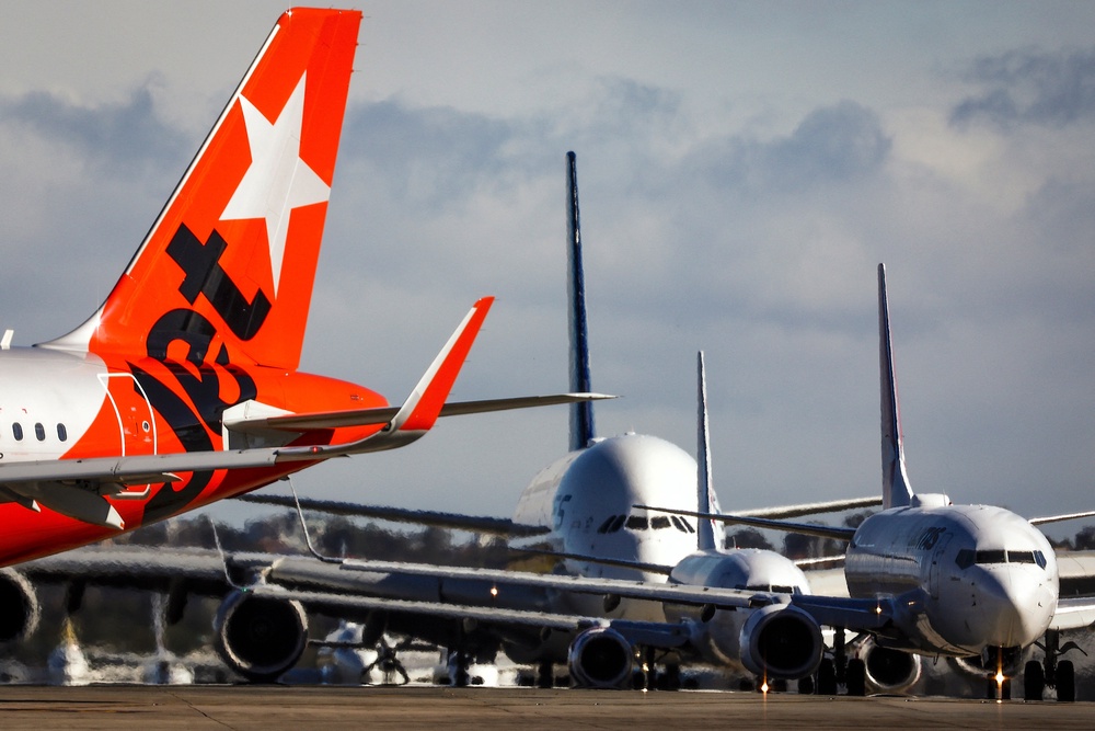A Jetstar Airlines Airbus A321 plane lines up with other aircraft on the runway at the Sydney international airport on 25 June 2025 (AFP/Getty)