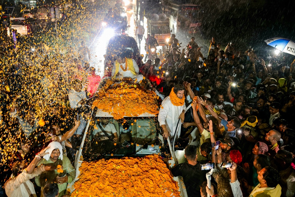 Supporters of Prashant Kishor welcome him with marigold garlands during a rally in Darbhanga, Bihar (AFP/Getty)
