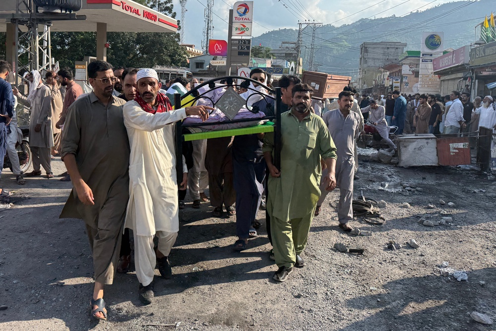 People attend the funeral prayers of a man who was reportedly killed during clashes between protesters and police in Muzaffarabad, capital of AJK (AFP/Getty)