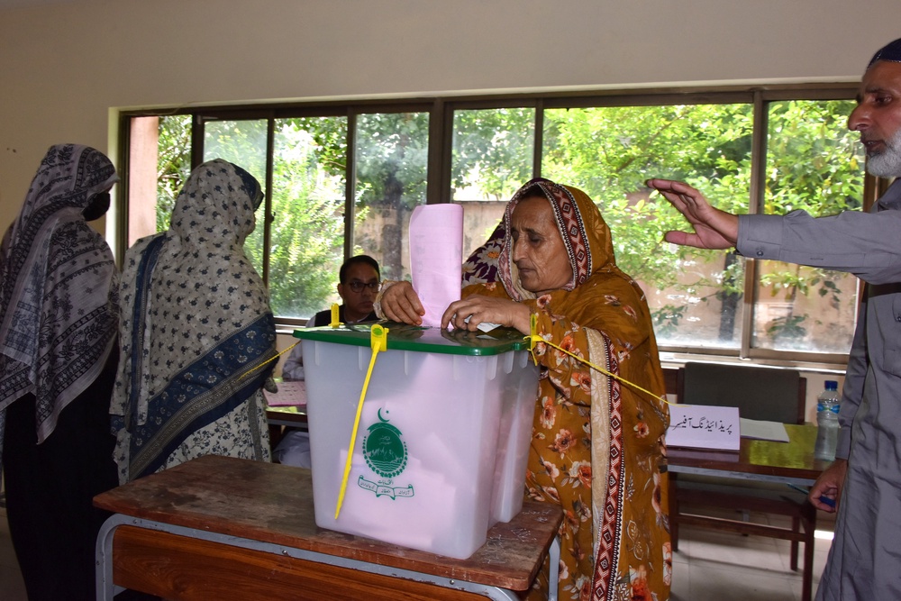 A woman votes in the second phase of the legislative assembly election in Muzaffarabad on 2 August 2026 (AFP/Getty)