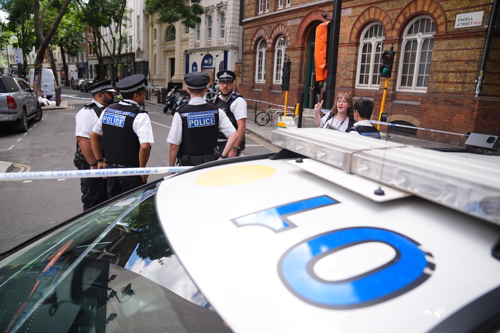 Emergency services near the scene on Endell Street in Covent Garden after four people were stabbed (PA)