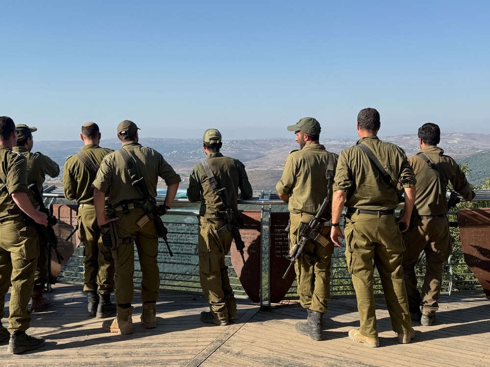 Israeli soldiers look towards Lebanon (Reuters)