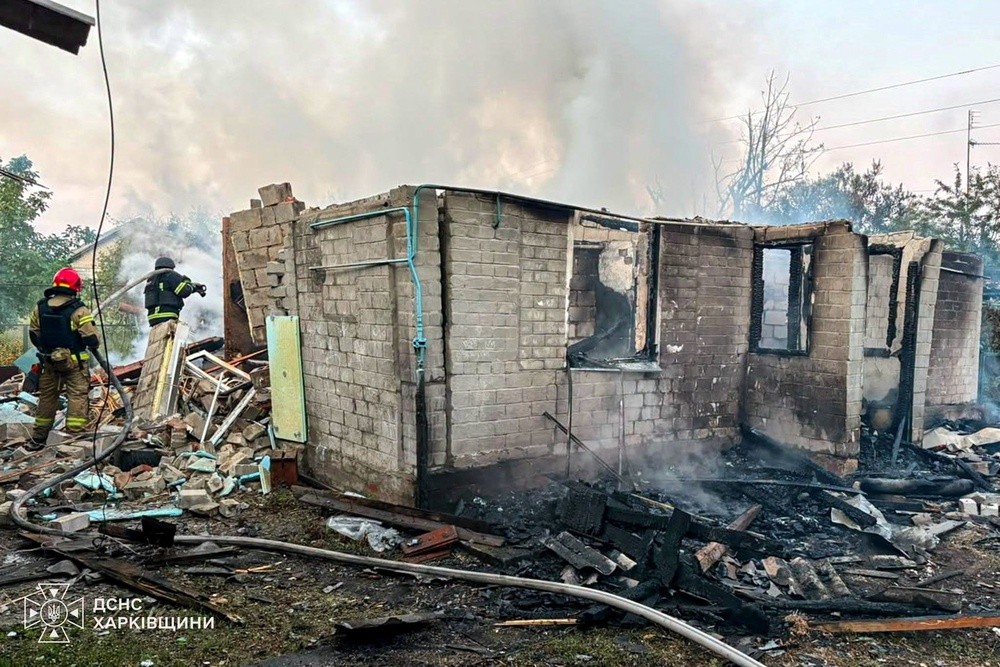 Firefighters work at the site of a private house destroyed during overnight Russian drone strikes in Balakiia, Kharkiv (Reuters)