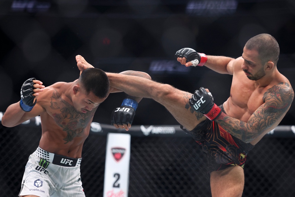 Alexandre Pantoja (right) suffered an early injury in December as he lost his belt to Joshua Van (Getty)