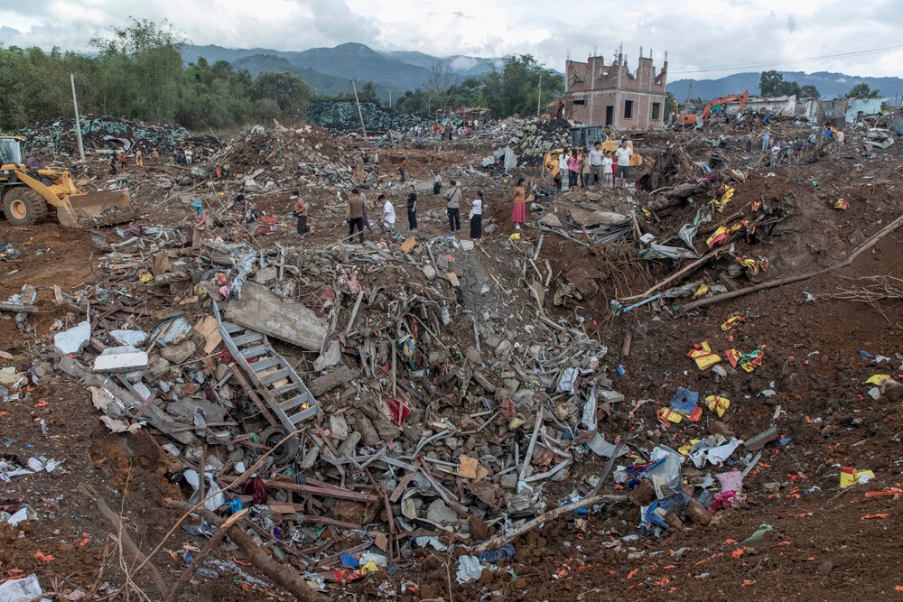 Rescuers and residents search the rubble following an explosion in Kaung Tat village in Shan state, Myanmar, on 1 June 2026 (AFP/Getty)