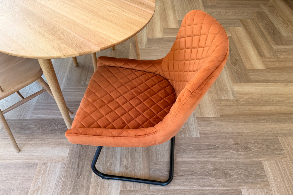 The chair slides smoothly under the table without snagging on the floor (Emily Peck/The Independent)
